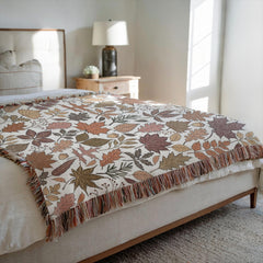 Cozy fall scene with cream fall woven blanket blanket on bed