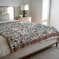 Floral patterned throw blanket on a bed in a bedroom setting