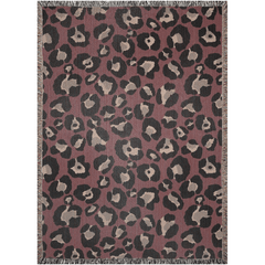 Woven throw blanket featuring bold leopard print in burgundy and black, with fringed edges, perfect for maxmimalist decor.
