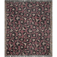 Bold burgundy animal print woven throw blanket with fringed edges, perfect for stylish decor and cozy comfort.