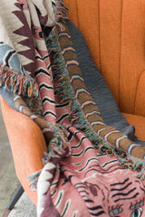 Tiger motif blanket draped over sofa
