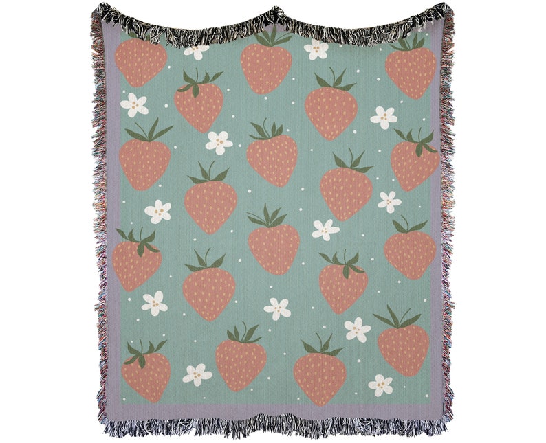 Strawberry woven blanket with pastel green background and fringe
