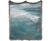 Ocean Waves Throw Blanket folded neatly on a sofa – coastal-inspired home décor