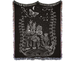 Sagittarius woven blanket featuring intricate designs of mushrooms, butterflies, and stars with colorful fringed edges.