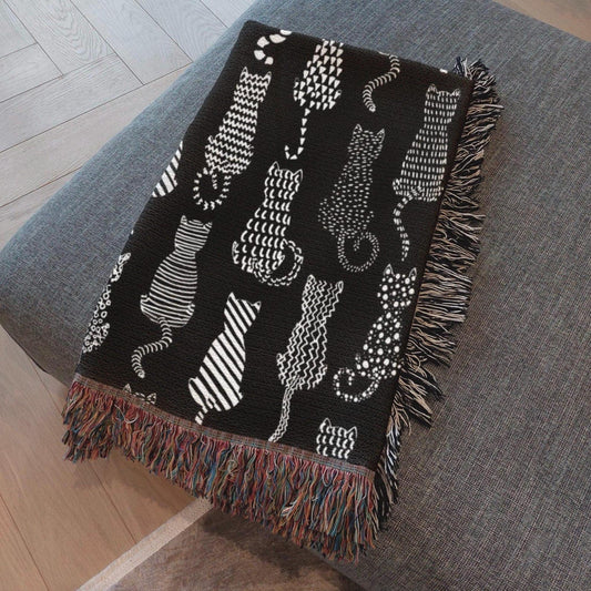 alt="Handcrafted woven blanket draped on a cozy chair, symbolizing comfort, purpose, and storytelling"