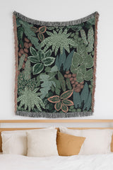 Tropical leaf wall tapestry displayed in modern bedroom above wooden headboard
