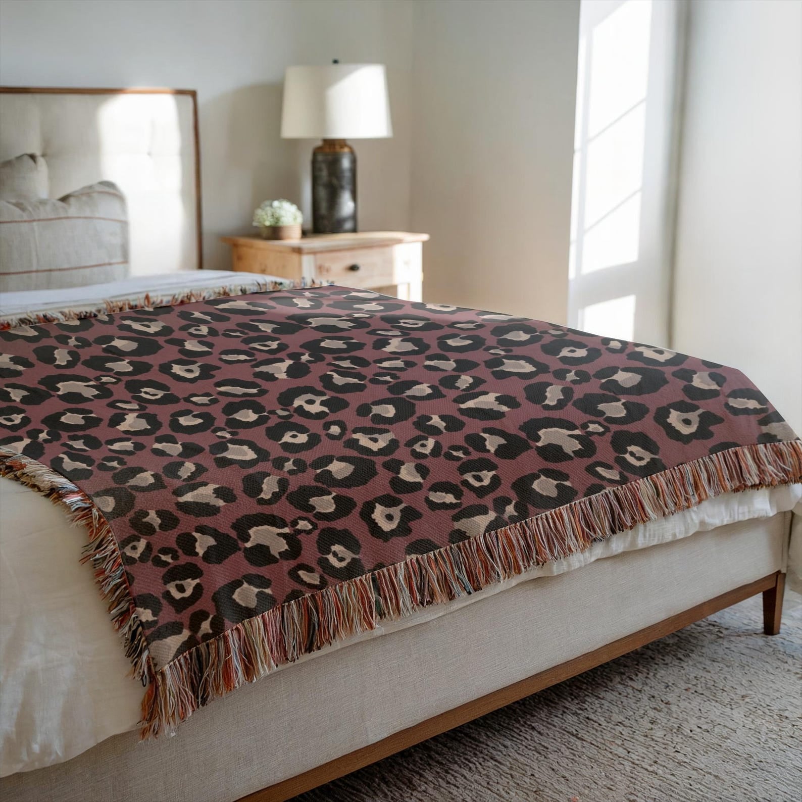 Maximalist animal print throw blanket styled in bedroom setting showing drape and fall on a bed
