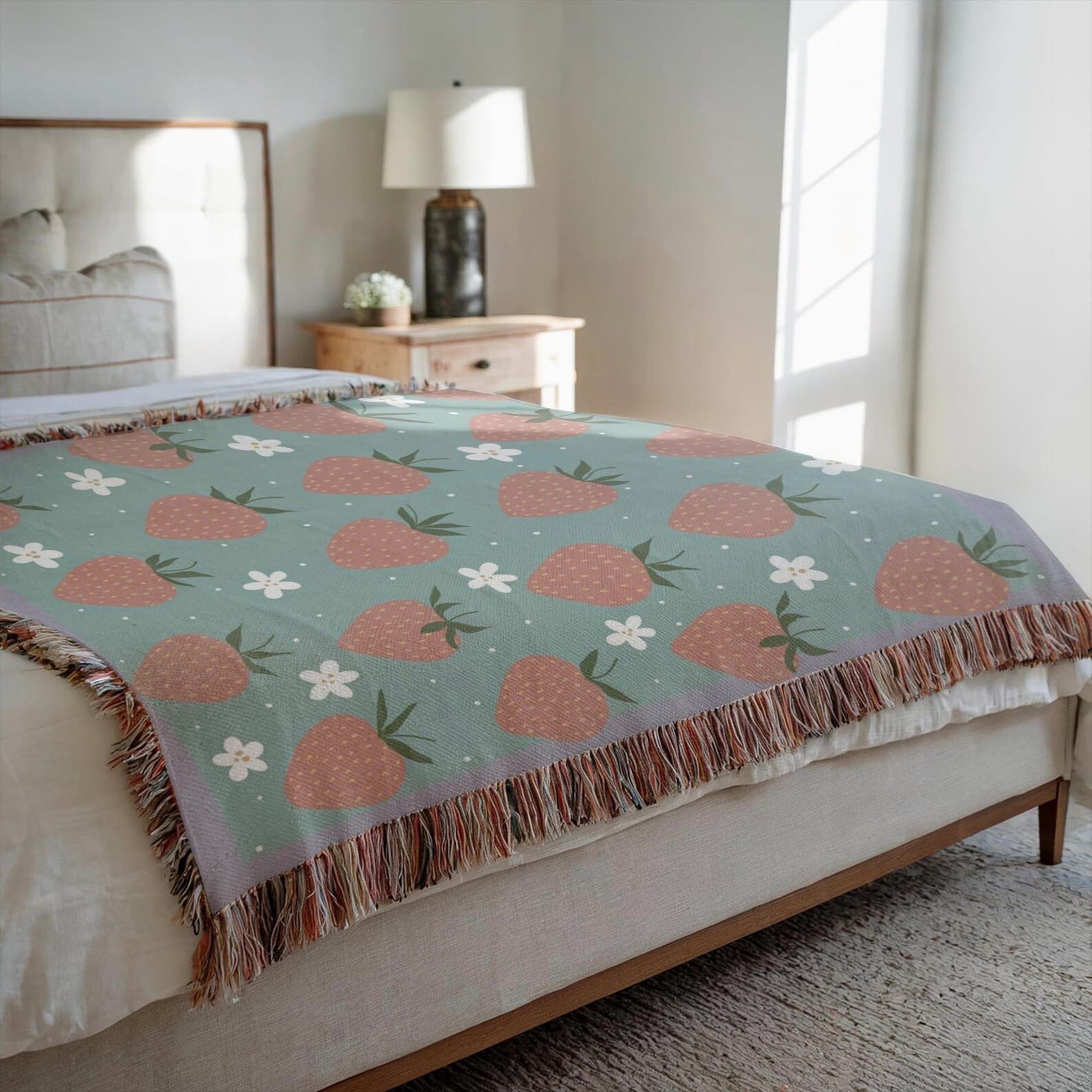 Coquette style strawberry woven blanket on bed as bedspread