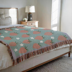 Coquette style strawberry woven blanket on bed as bedspread