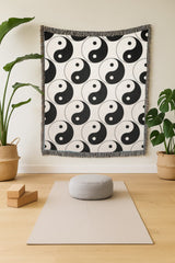 Yin yang woven blanket styled as wall tapestry in zen yoga studio